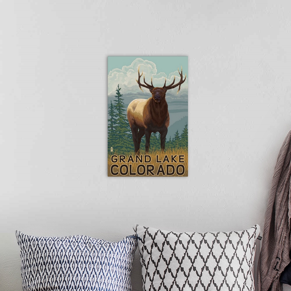 A bohemian room featuring A stylized art poster of an elk climbing a hill in a grassy meadow above lakes and forests.