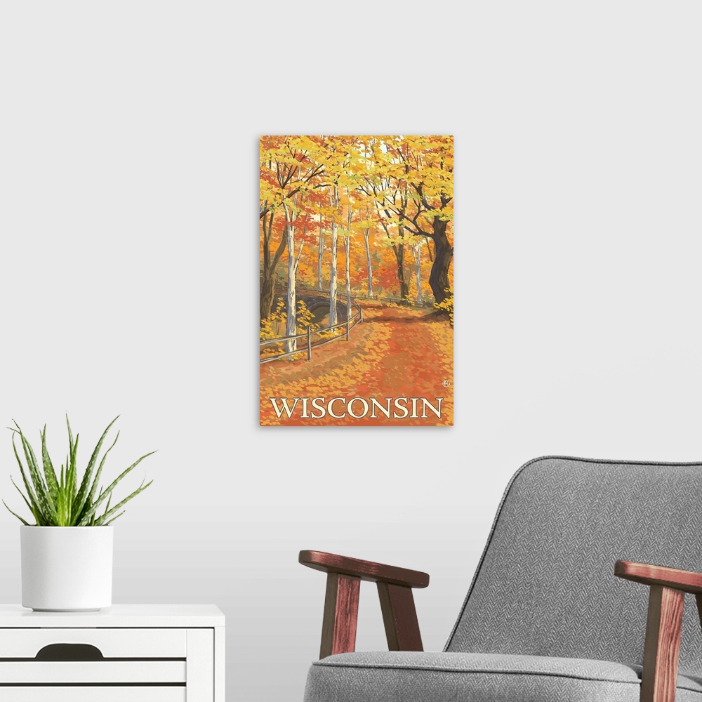 A modern room featuring A stylized art poster of a road through an autumn forest that passes over a stone arch bridge.