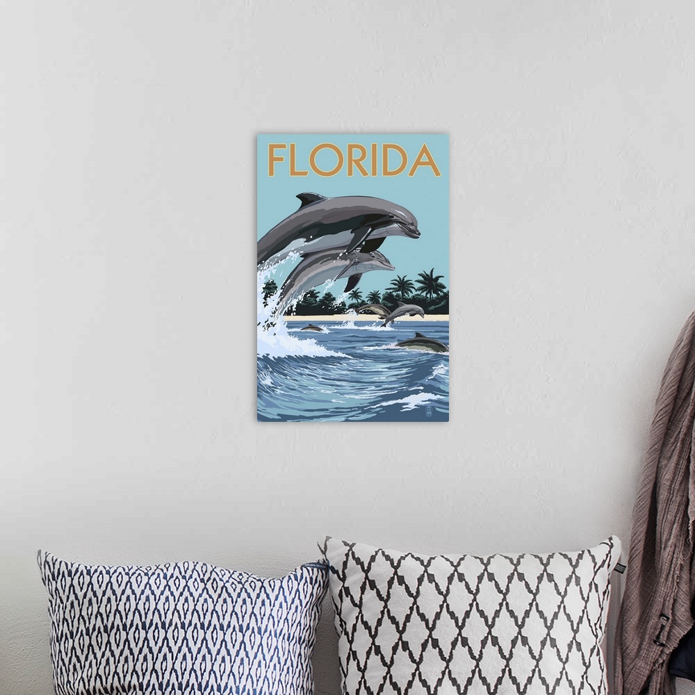 A bohemian room featuring A stylized art poster of a bottle nose dolphins jumping in and out of the surf off the coast of a...