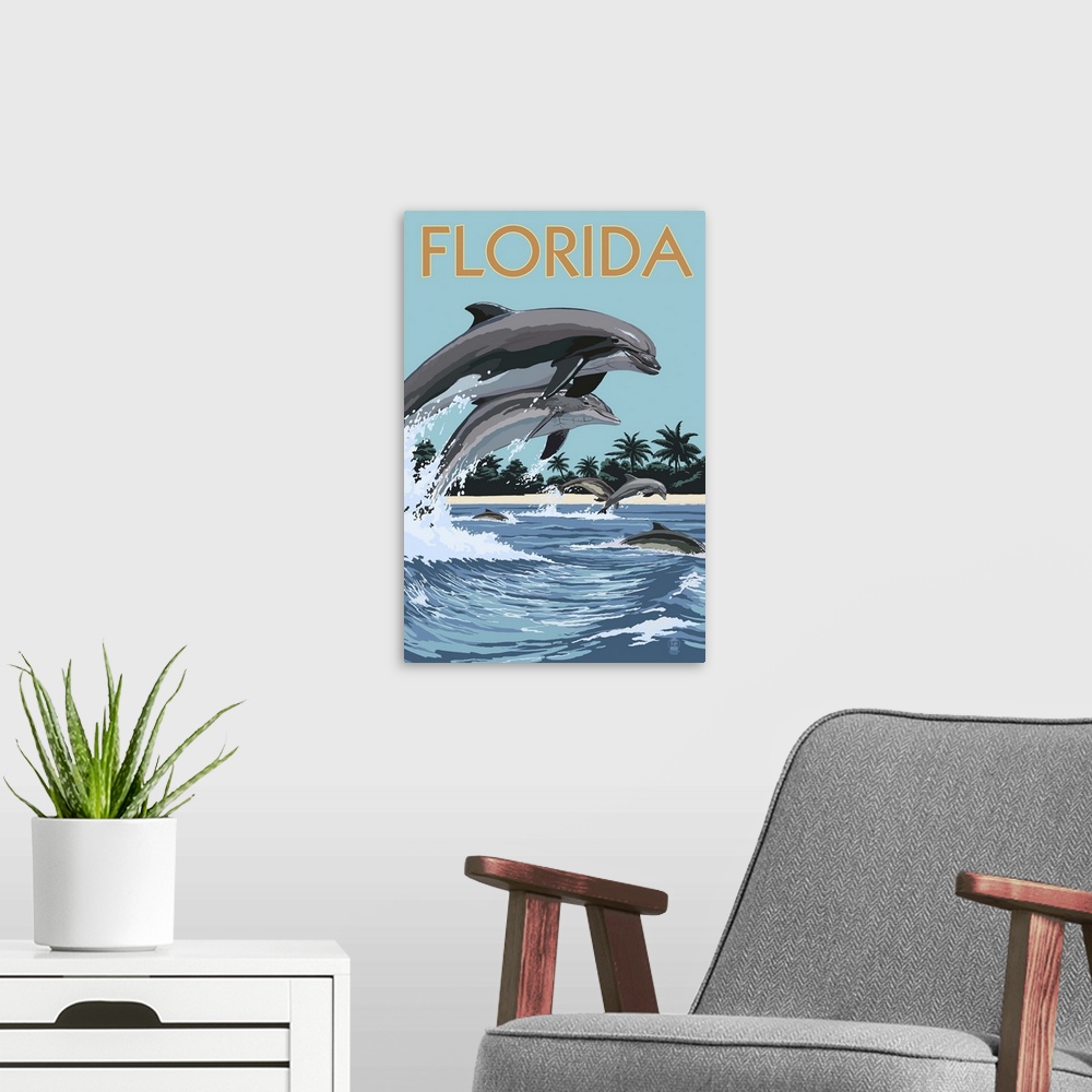 A modern room featuring A stylized art poster of a bottle nose dolphins jumping in and out of the surf off the coast of a...