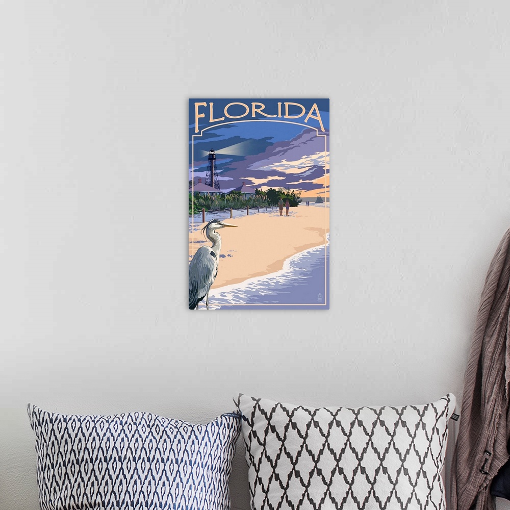 A bohemian room featuring Retro stylized art poster of a blue heron on a beach, with a lighthouse in the background.