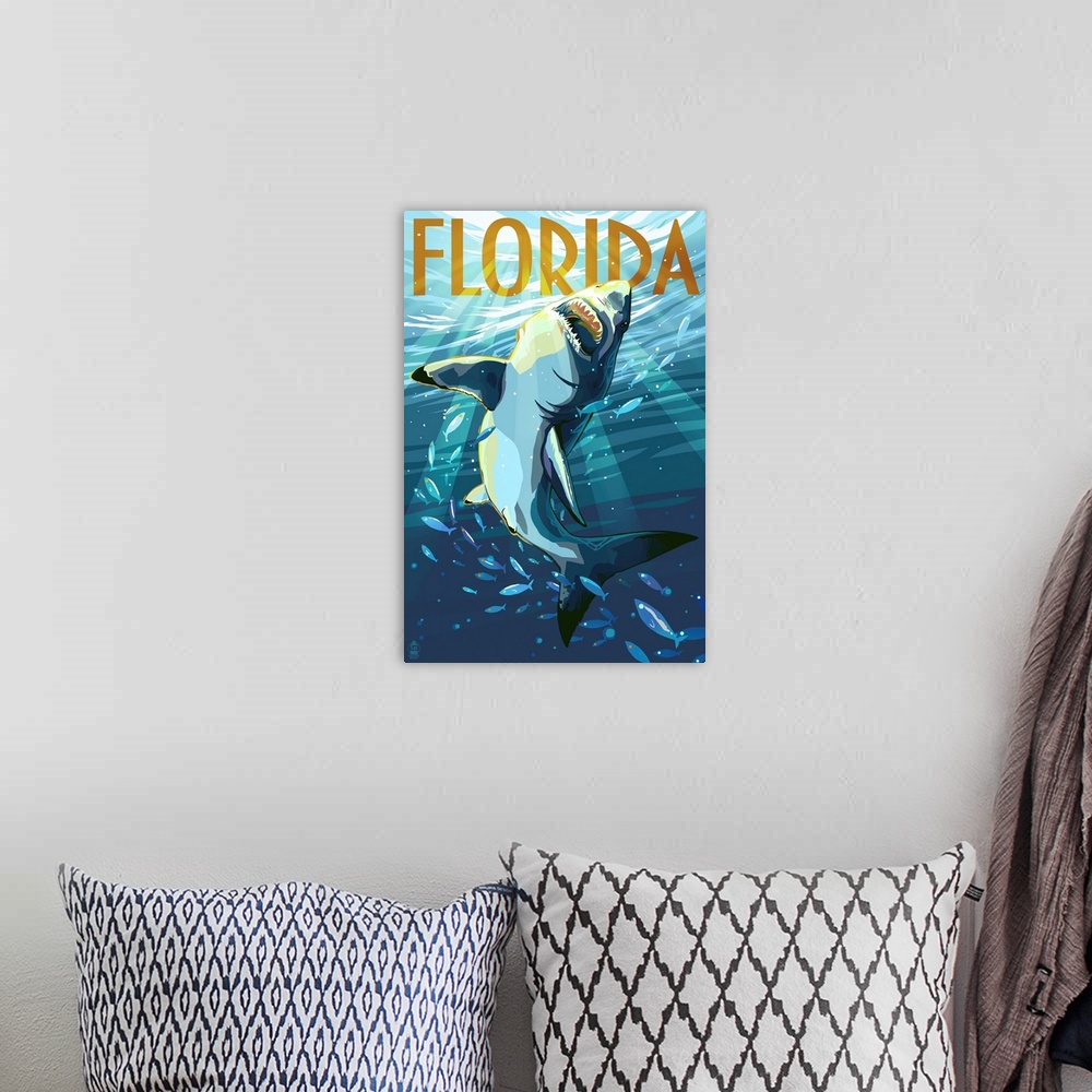 A bohemian room featuring A stylized art poster of a great white shark writhing underwater through a school of fish.