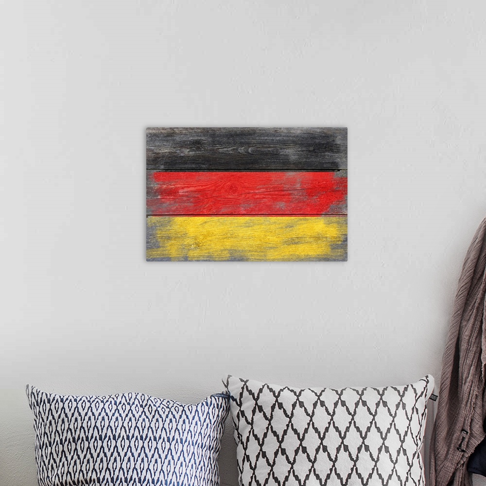 A bohemian room featuring The flag of Germany with a weathered wooden board effect.