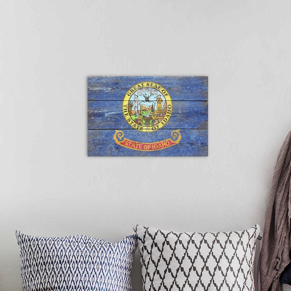 A bohemian room featuring The flag of Idaho with a weathered wooden board effect.