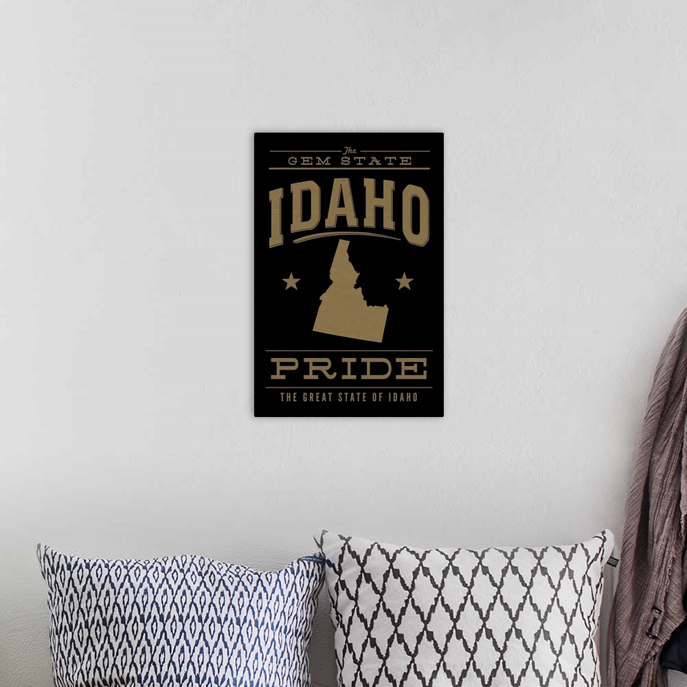 A bohemian room featuring The Idaho state outline on black with gold text.
