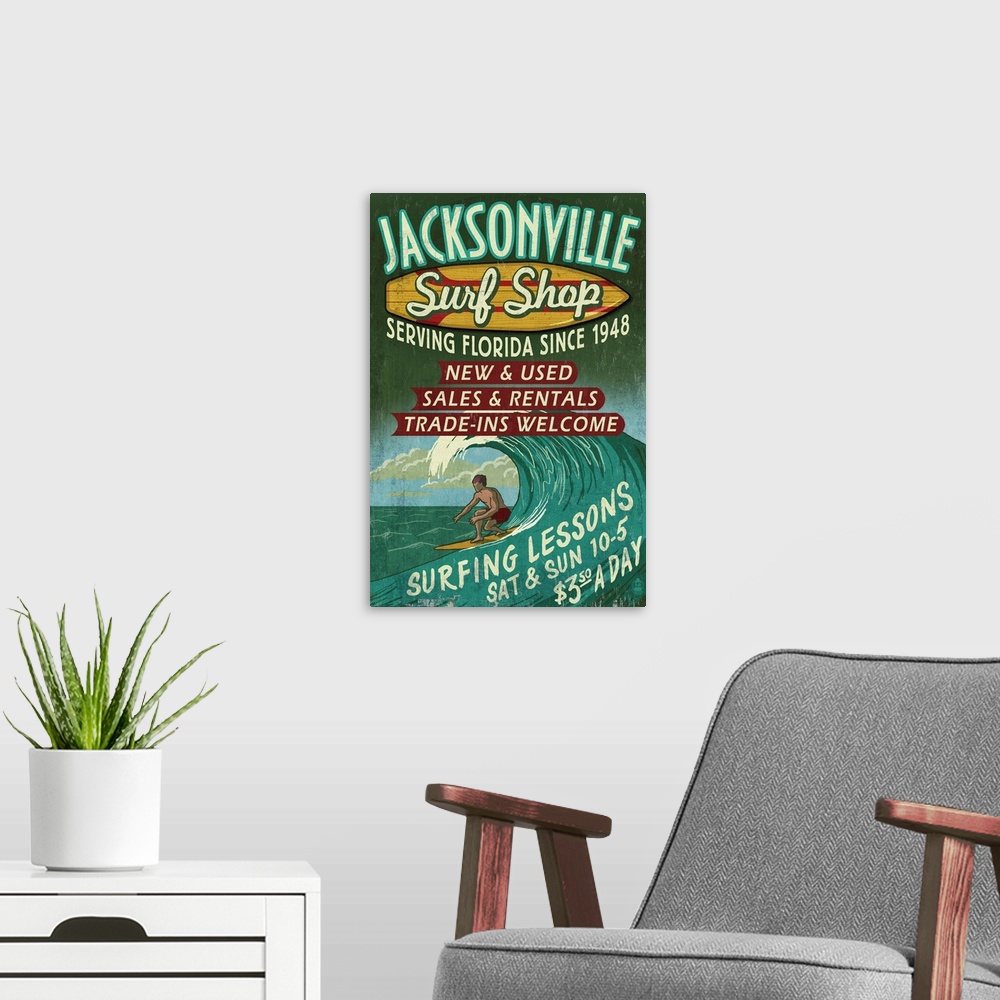 A modern room featuring Retro stylized art poster of a vintage sign, with a surfer in a curled wave.