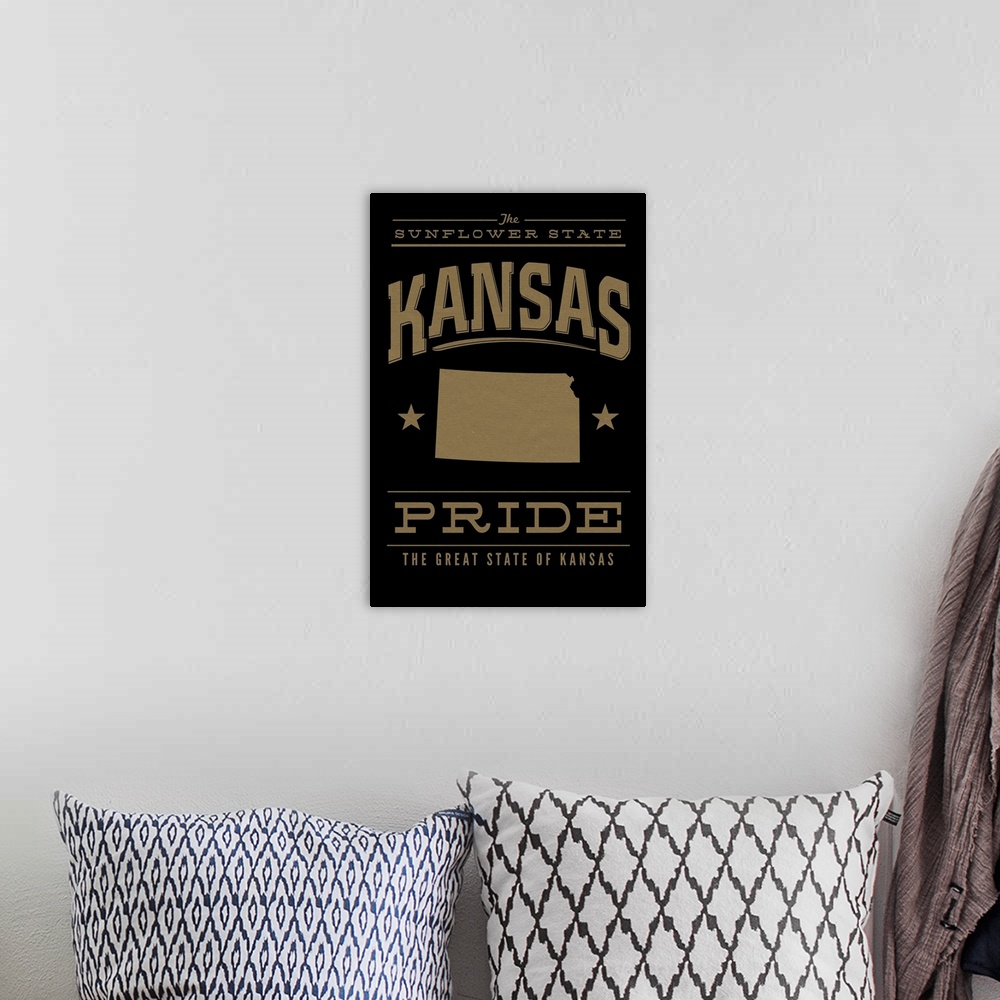 A bohemian room featuring The Kansas state outline on black with gold text.