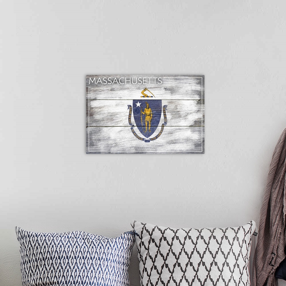 A bohemian room featuring The flag of Massachusetts with a weathered wooden board effect.