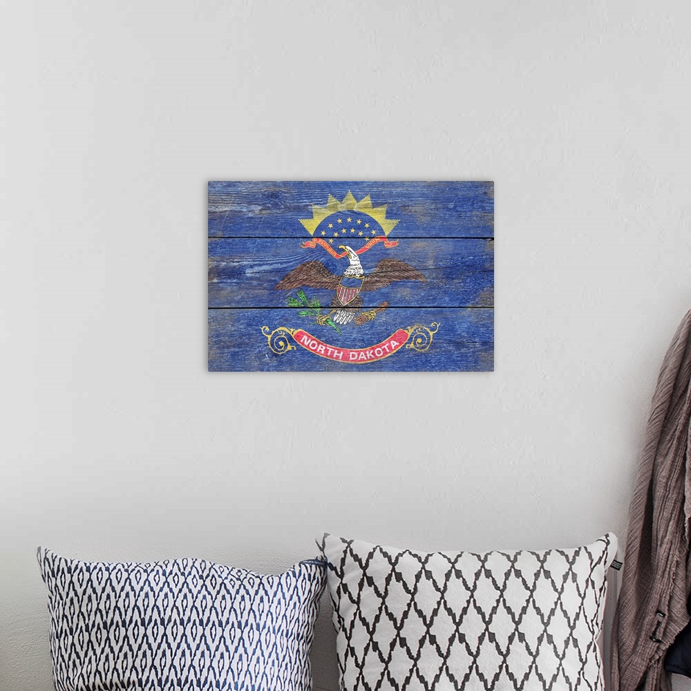 A bohemian room featuring The flag of North Dakota with a weathered wooden board effect.