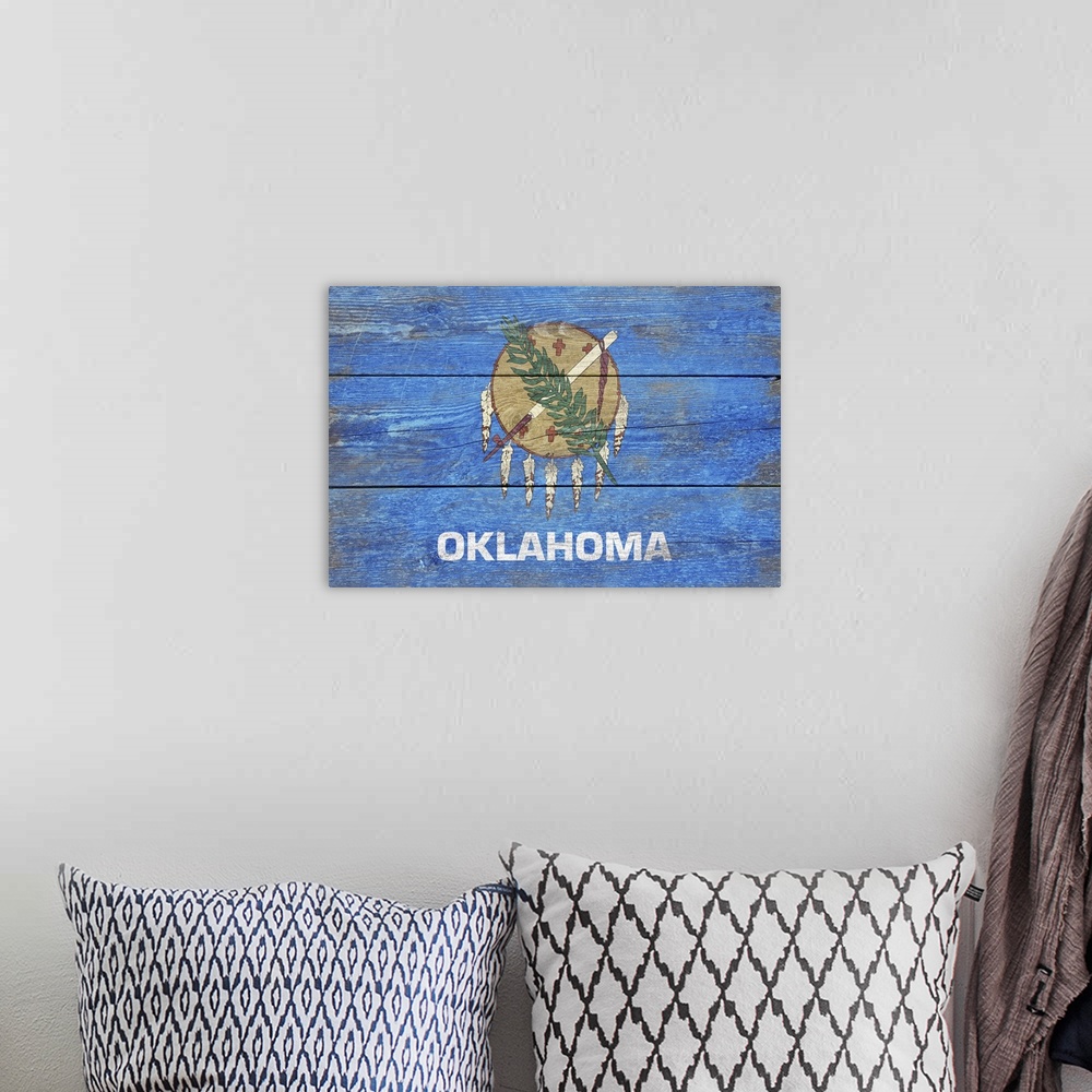 A bohemian room featuring The flag of Oklahoma with a weathered wooden board effect.