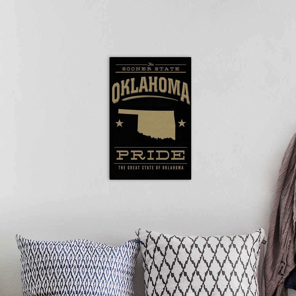 A bohemian room featuring The Oklahoma state outline on black with gold text.