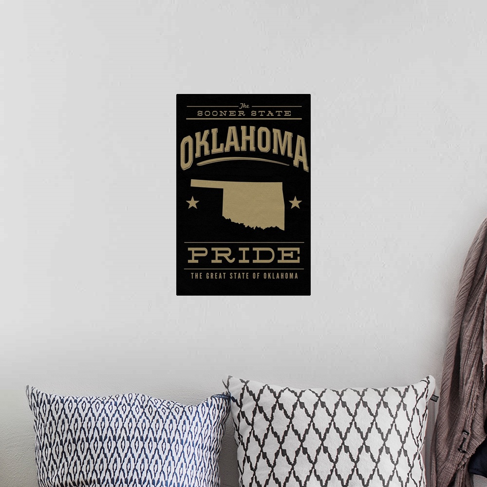 A bohemian room featuring The Oklahoma state outline on black with gold text.