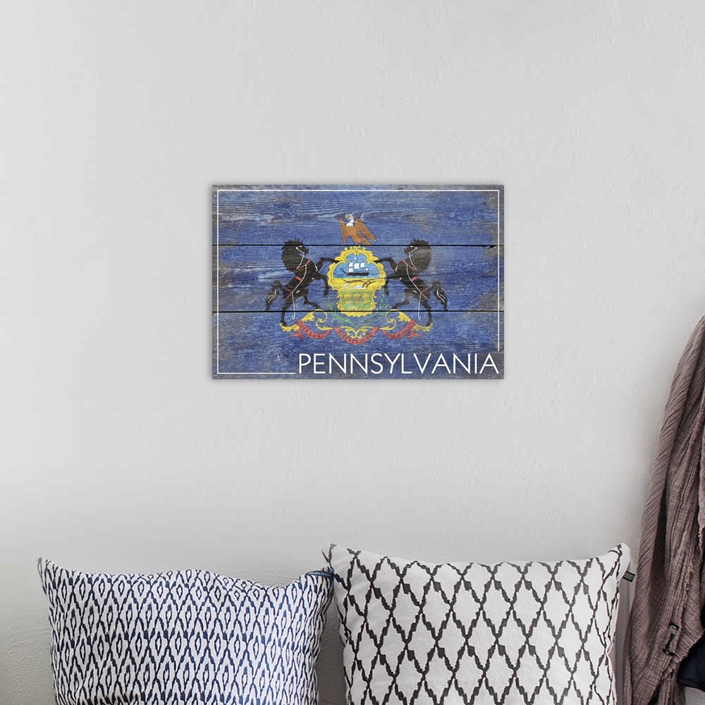 A bohemian room featuring The flag of Pennsylvania with a weathered wooden board effect.