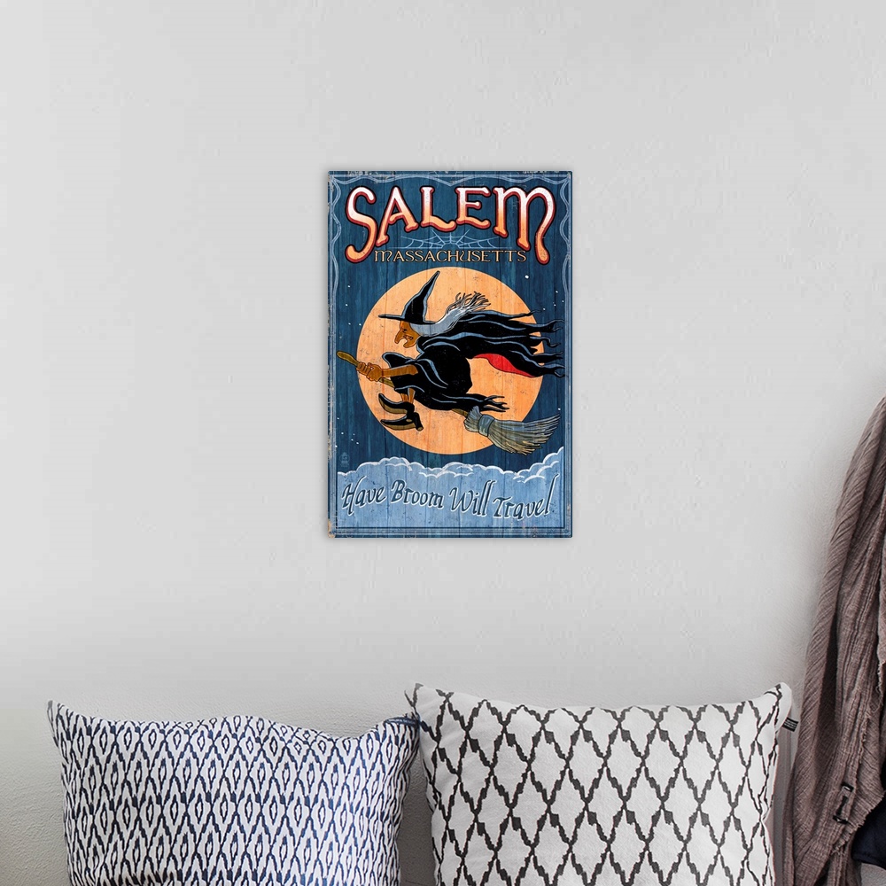 A bohemian room featuring Retro stylized art poster of a vintage sign with a profile of a witch flying in front of a moon.
