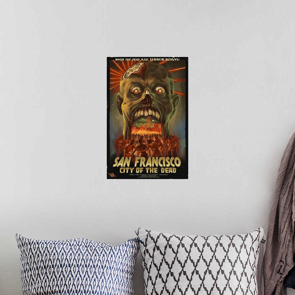 A bohemian room featuring Retro stylized art poster of a zombie head opening its mouth, to reveal a city being being mobbed...