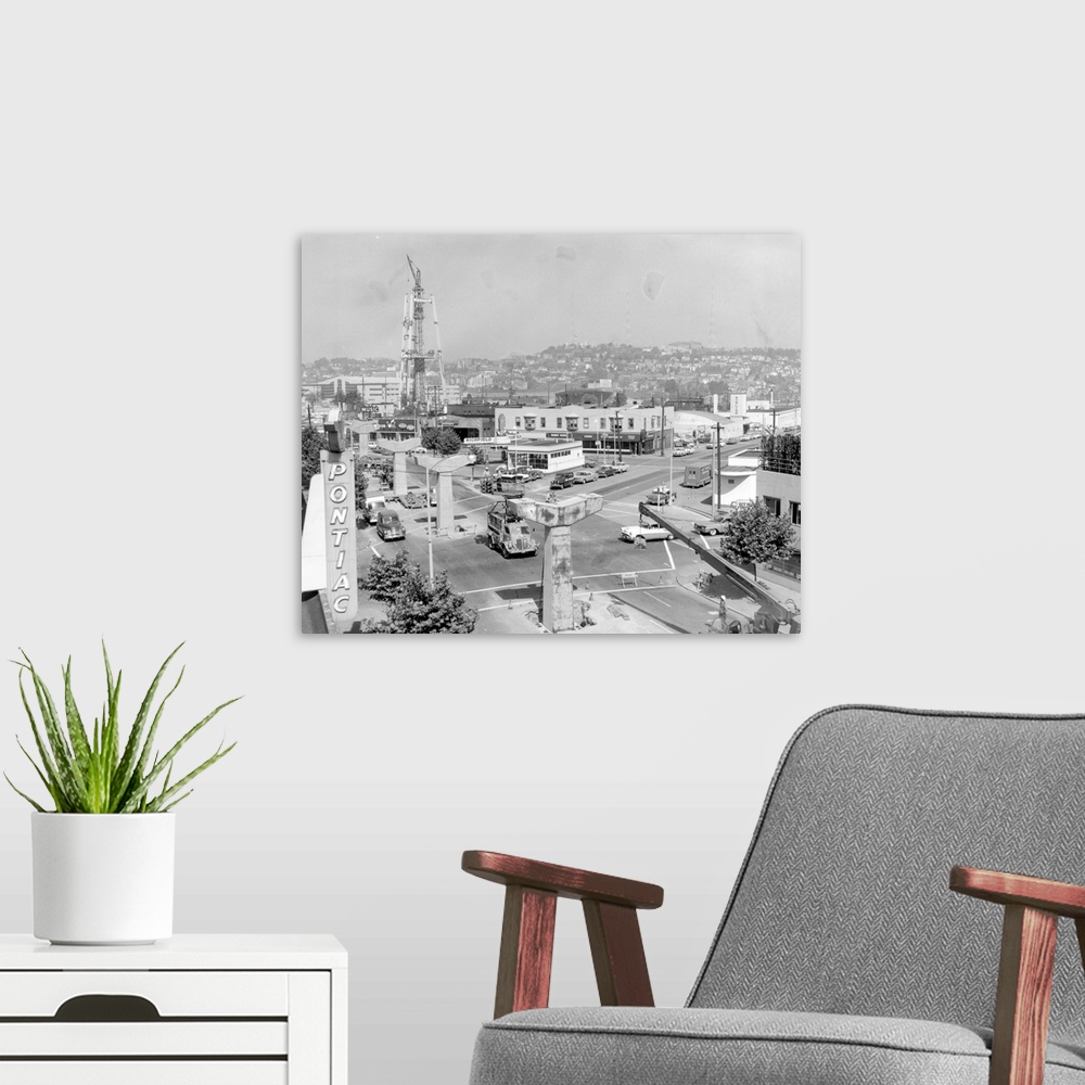 A modern room featuring Vintage photograph of the Space Needle in Seattle, Washington, being built.