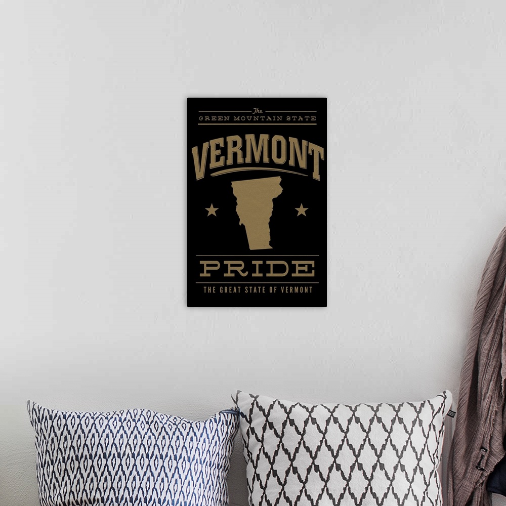 A bohemian room featuring The Vermont state outline on black with gold text.