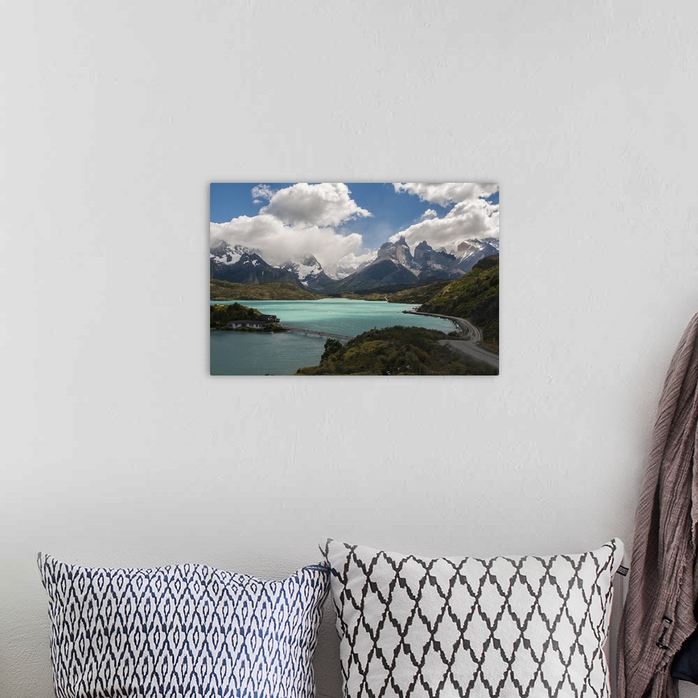A bohemian room featuring Photograph of an idyllic wilderness scene, with a crystal blue lake and mountain spires surrounde...