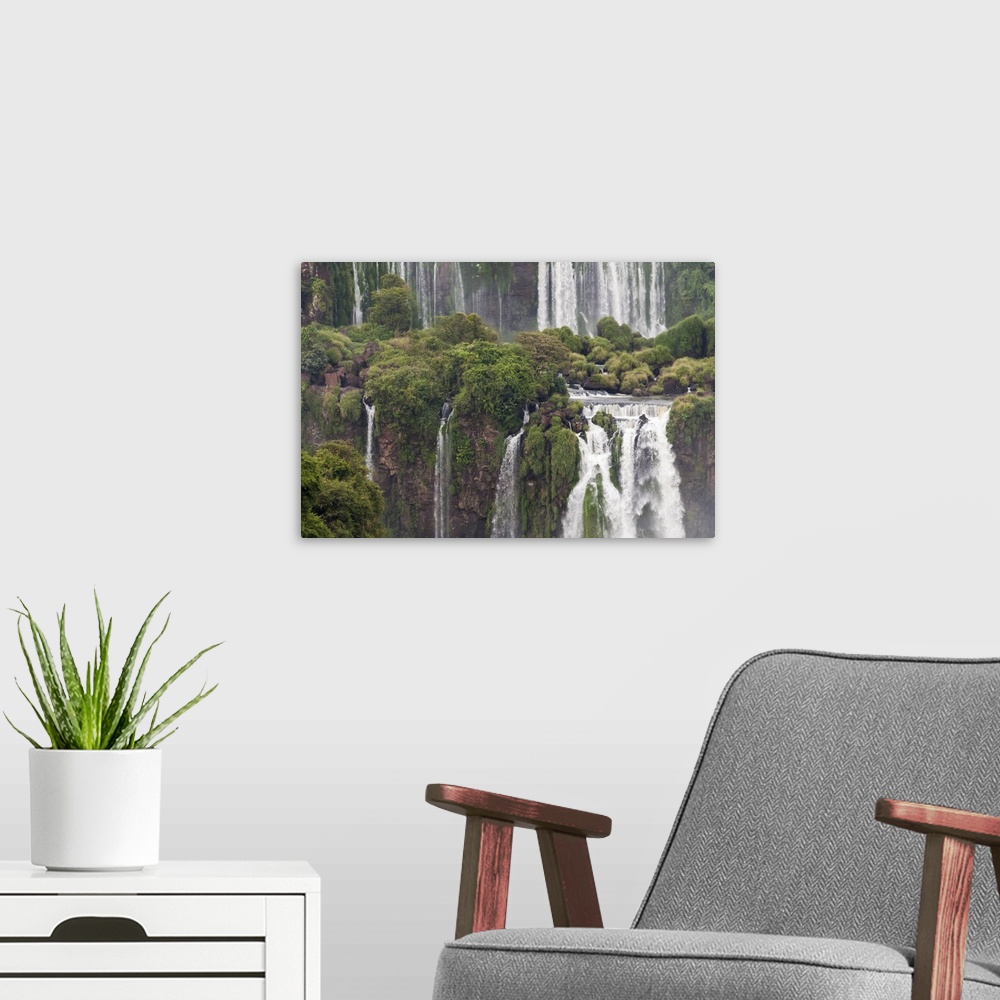 A modern room featuring Photograph of massive waterfalls flowing down over lush jungle cliffs.
