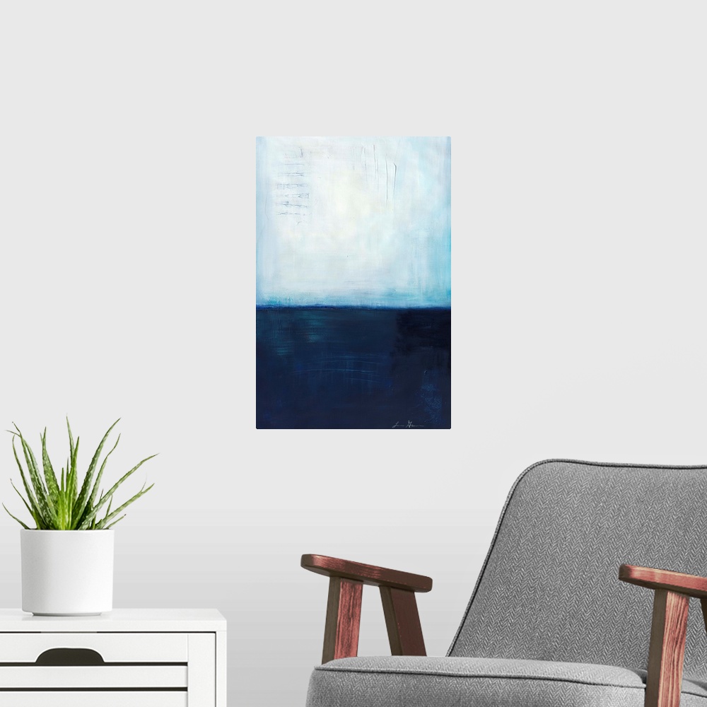 A modern room featuring Contemporary abstract painting using dark blue and light blue colors meeting almost in the middle...