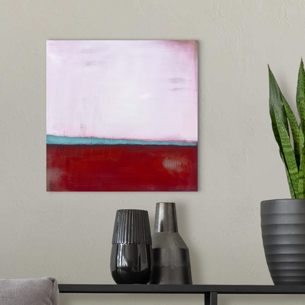 A modern room featuring Square, abstract painting featuring large blocks of color in pink and red with light blue accents