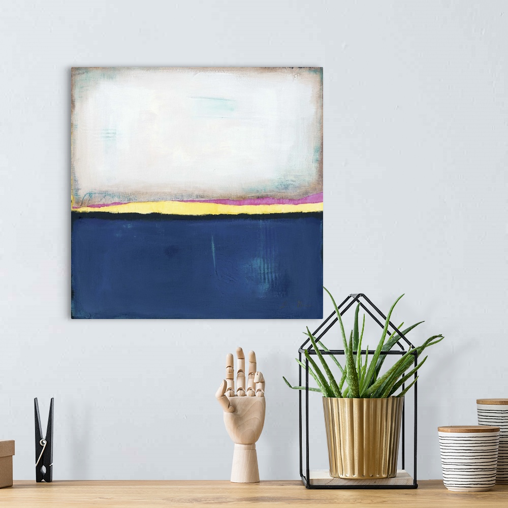 A bohemian room featuring Square, abstract painting featuring large blocks of color in white and dark blue with yellow and ...