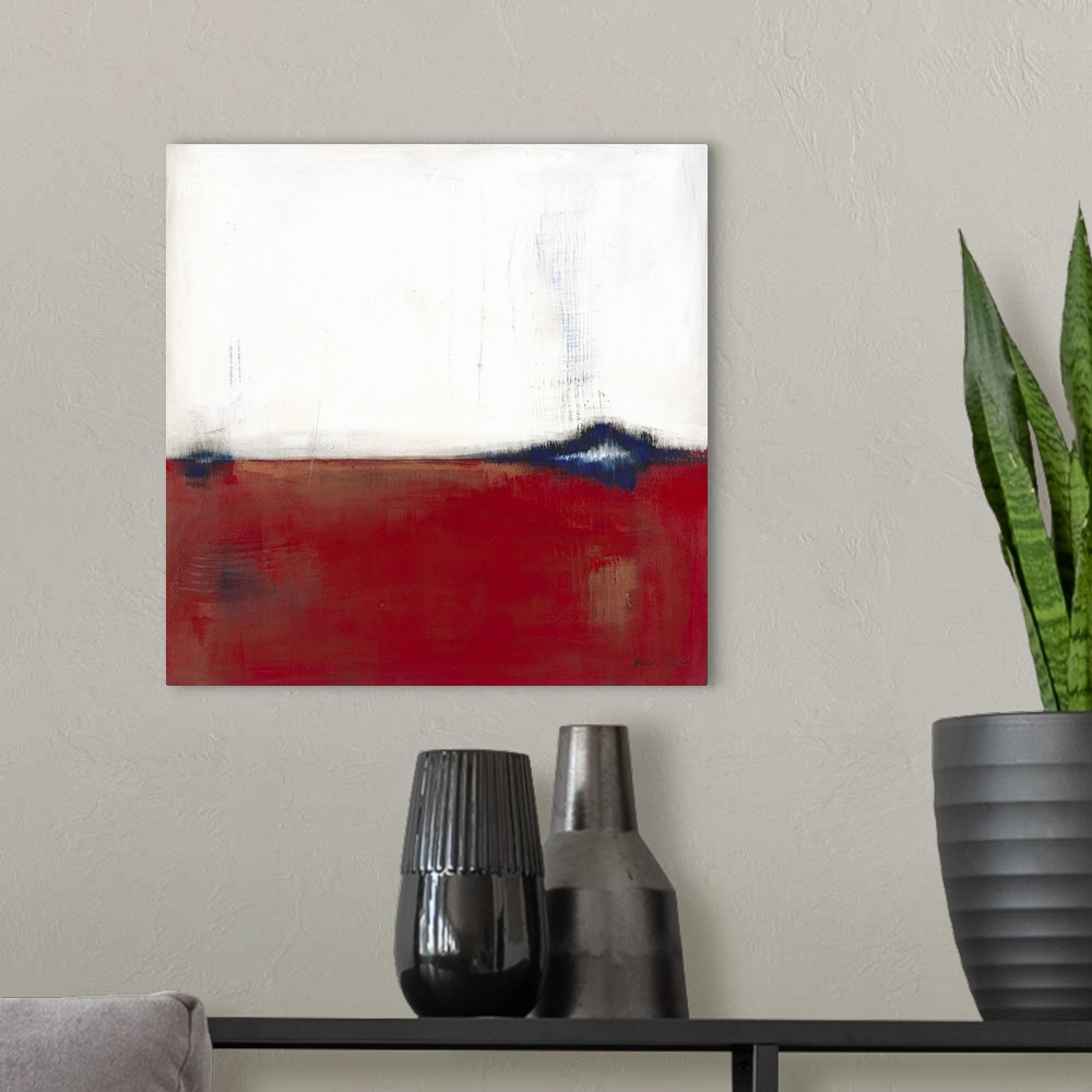 A modern room featuring Square, abstract painting featuring large blocks of color in white and red with blue accents