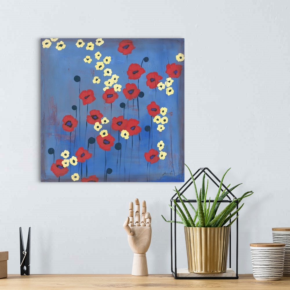 A bohemian room featuring Contemporary painting of red and yellow flowers against a blue background.