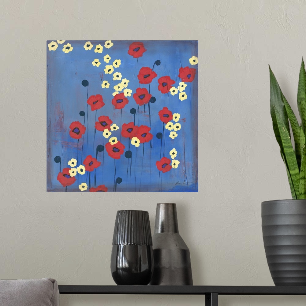 A modern room featuring Contemporary painting of red and yellow flowers against a blue background.