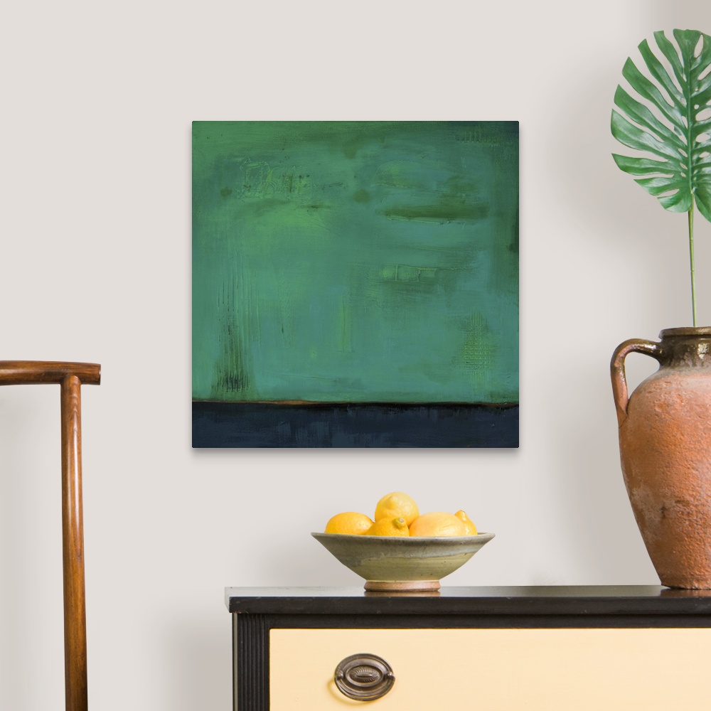 A traditional room featuring Square, abstract painting featuring large blocks of color in green and dark blue/gray