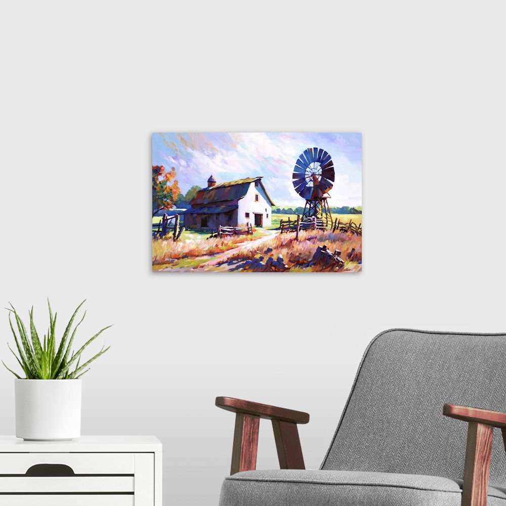 A modern room featuring This impressionistic landscape of a farmhouse and windmill set amidst the golden fields of the co...