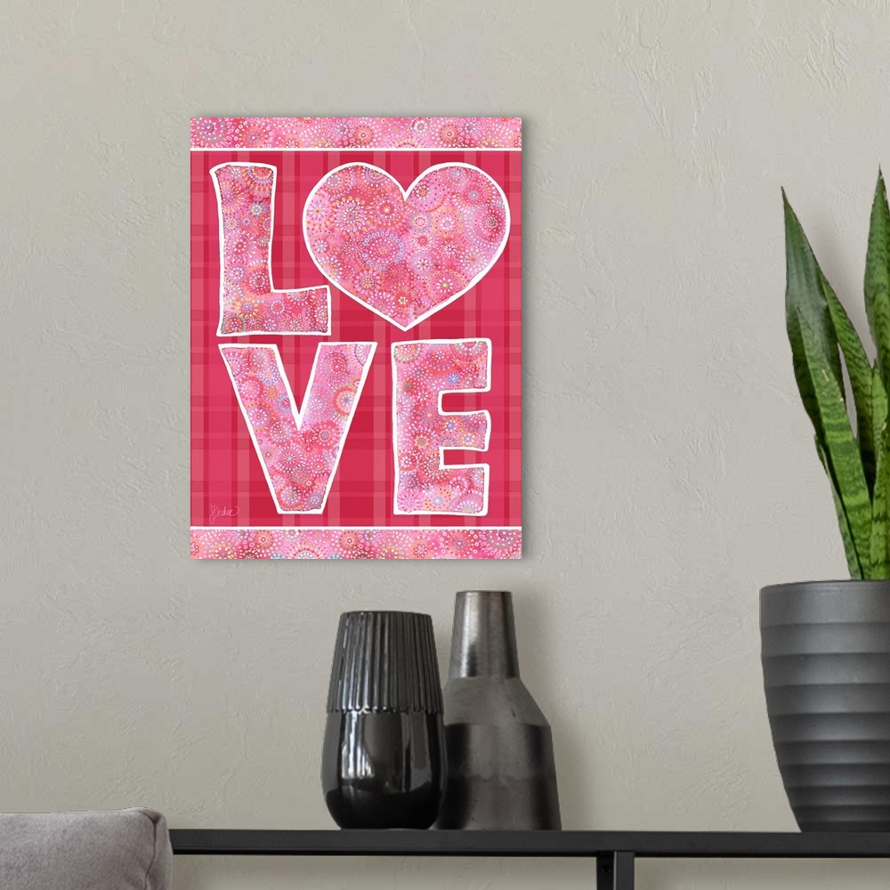 A modern room featuring Love design in pink on plaid. Decorative lettering and patterns.