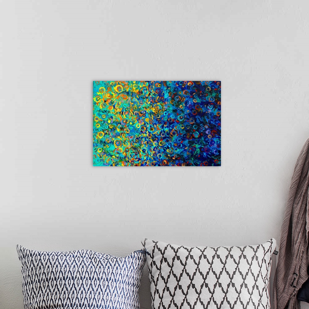 A bohemian room featuring Brightly colored contemporary artwork of a fingerpainting made with blues, yellows, and oranges.