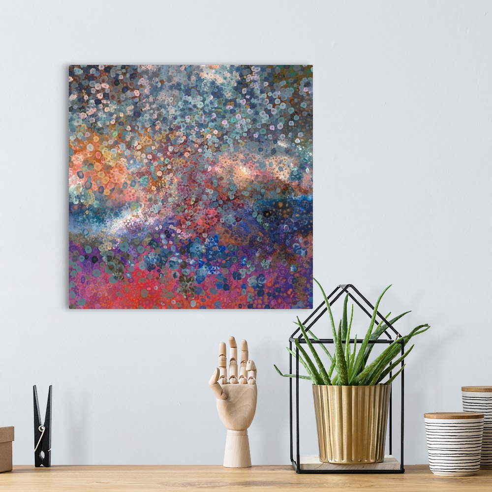 A bohemian room featuring Brightly colored contemporary artwork of a fingerpainting made with blues, pinks, and oranges.