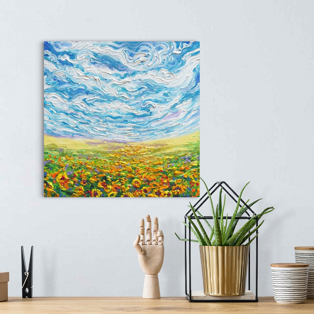A bohemian room featuring Brightly colored contemporary artwork of a landscape with sunflower field.