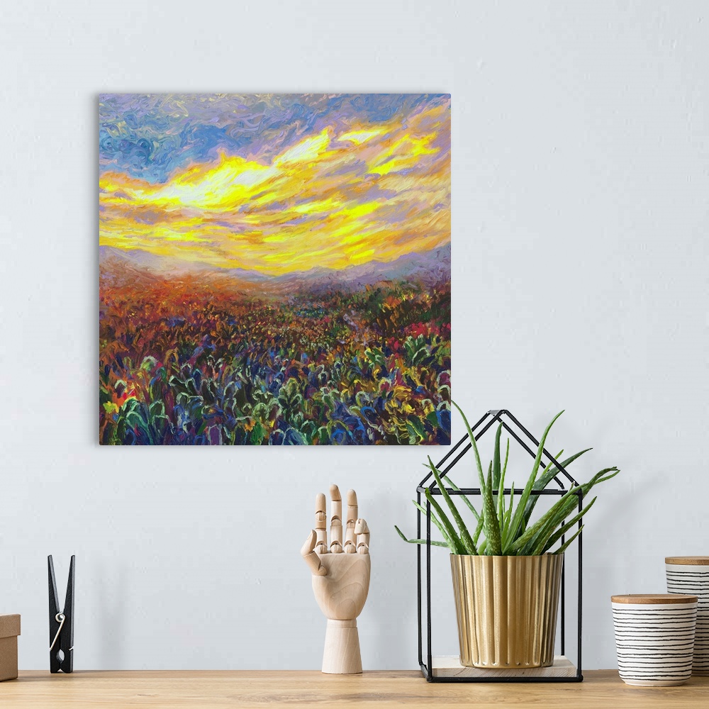 A bohemian room featuring Brightly colored contemporary artwork of a field of cacti at sunrise.