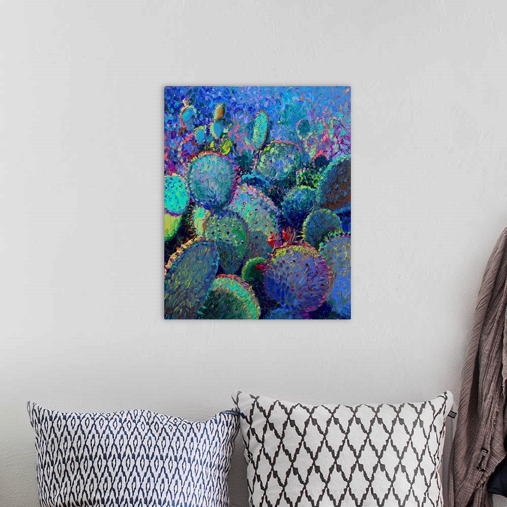 A bohemian room featuring Brightly colored contemporary artwork of a field of colorful cacti.