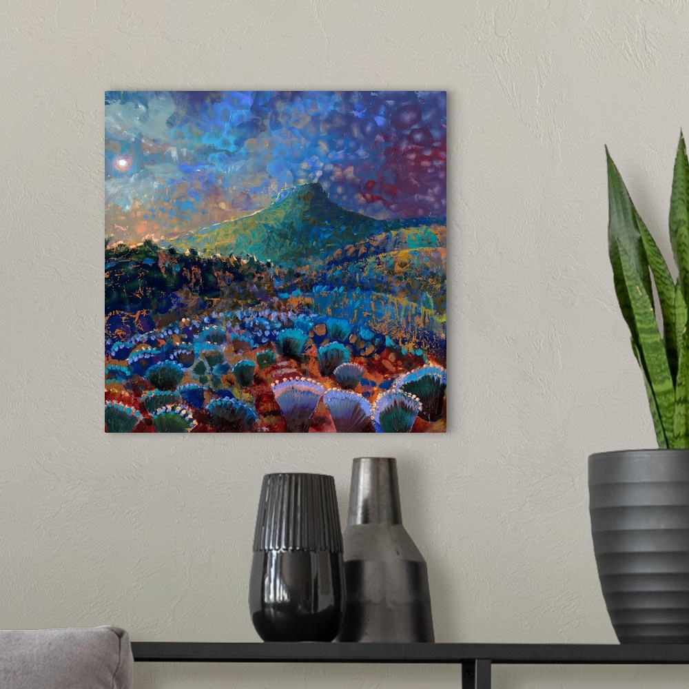 A modern room featuring Brightly colored contemporary artwork of a colorful landscape of cacti.
