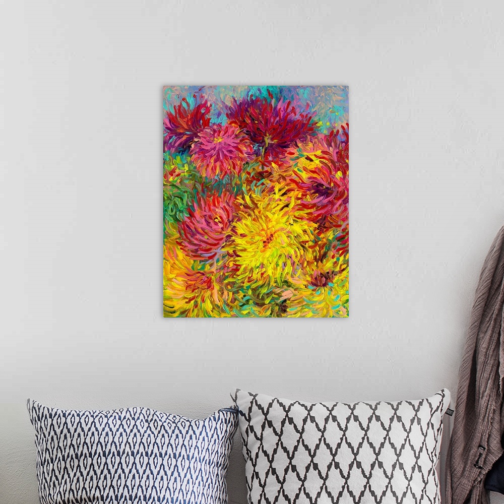 A bohemian room featuring Brightly colored contemporary artwork of red and yellow dahlias.