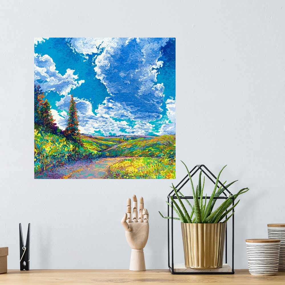 A bohemian room featuring Brightly colored contemporary artwork of a landscape with road and trees.