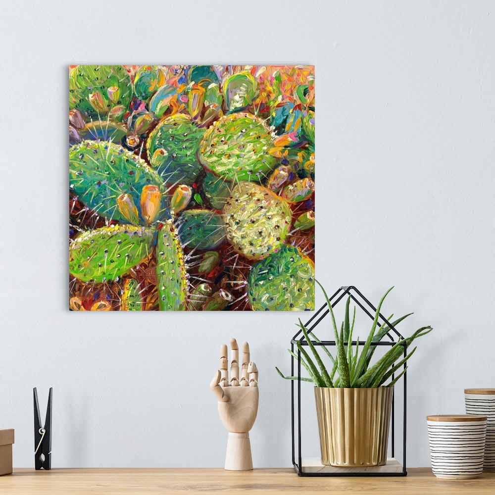 A bohemian room featuring Brightly colored contemporary artwork of cacti in color.
