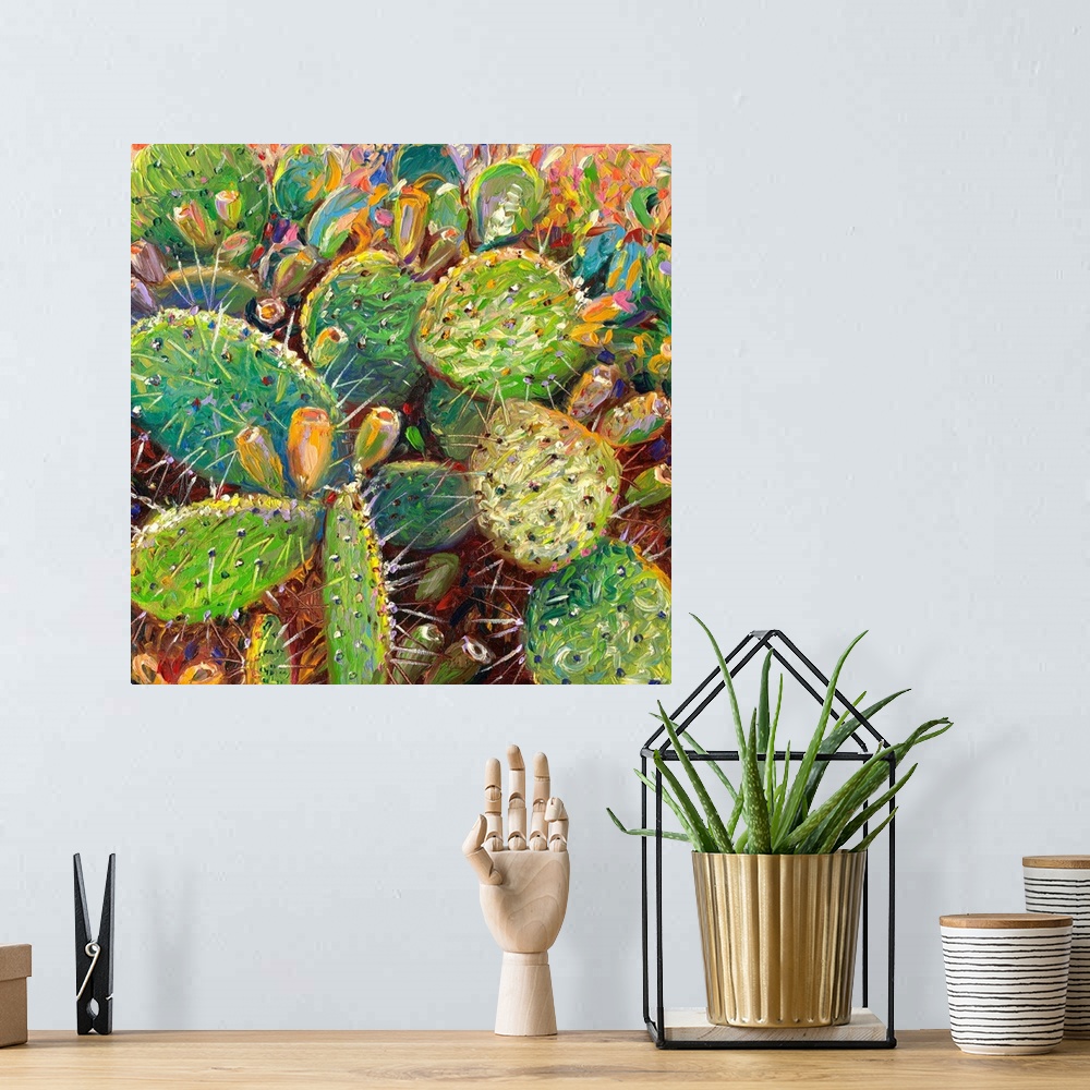A bohemian room featuring Brightly colored contemporary artwork of cacti in color.