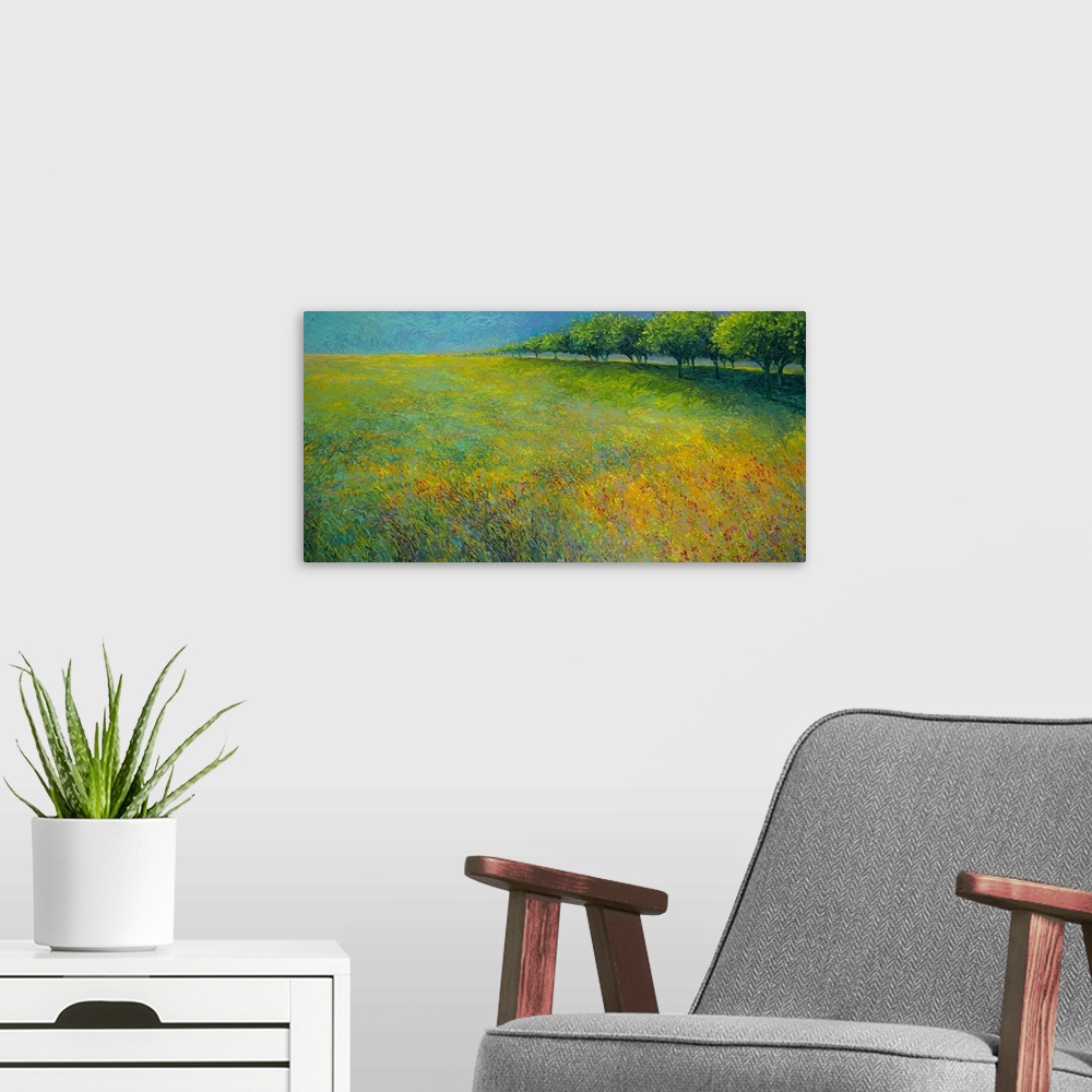 A modern room featuring Brightly colored contemporary artwork of a landscape of trees bordering a field of flowers.