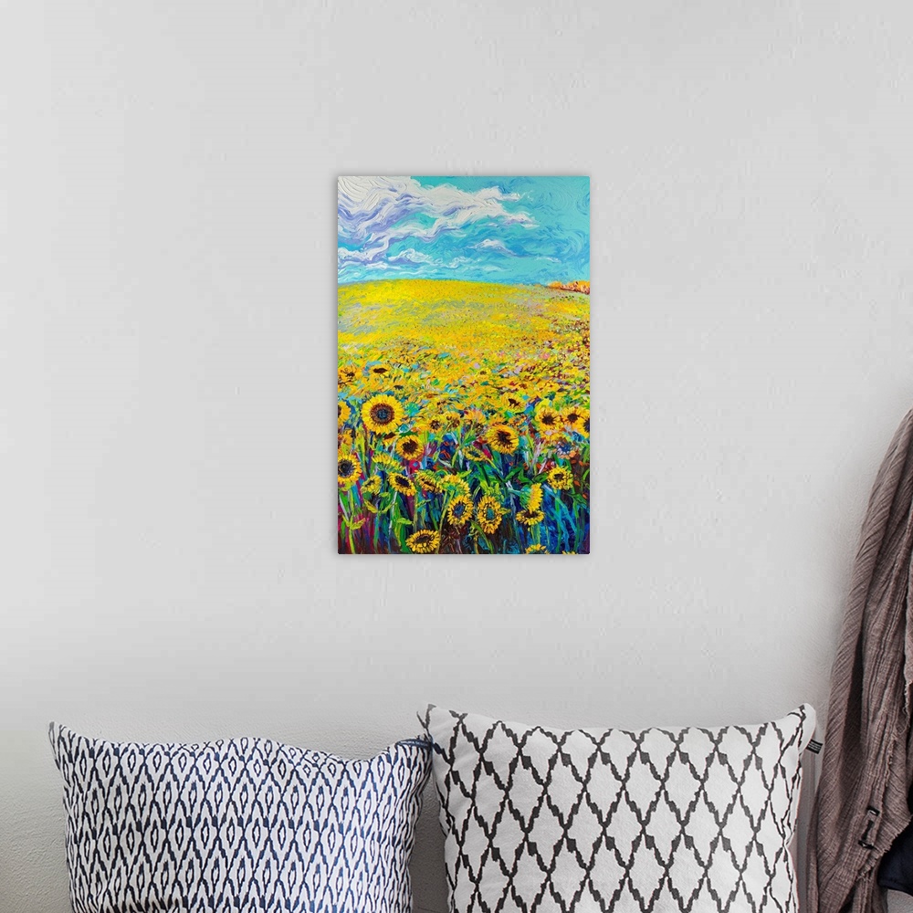 A bohemian room featuring Brightly colored triptych of a sunflower field. Panel 1 of 3.