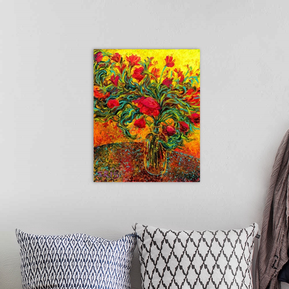 A bohemian room featuring Brightly colored contemporary artwork of red flowers in a vase.