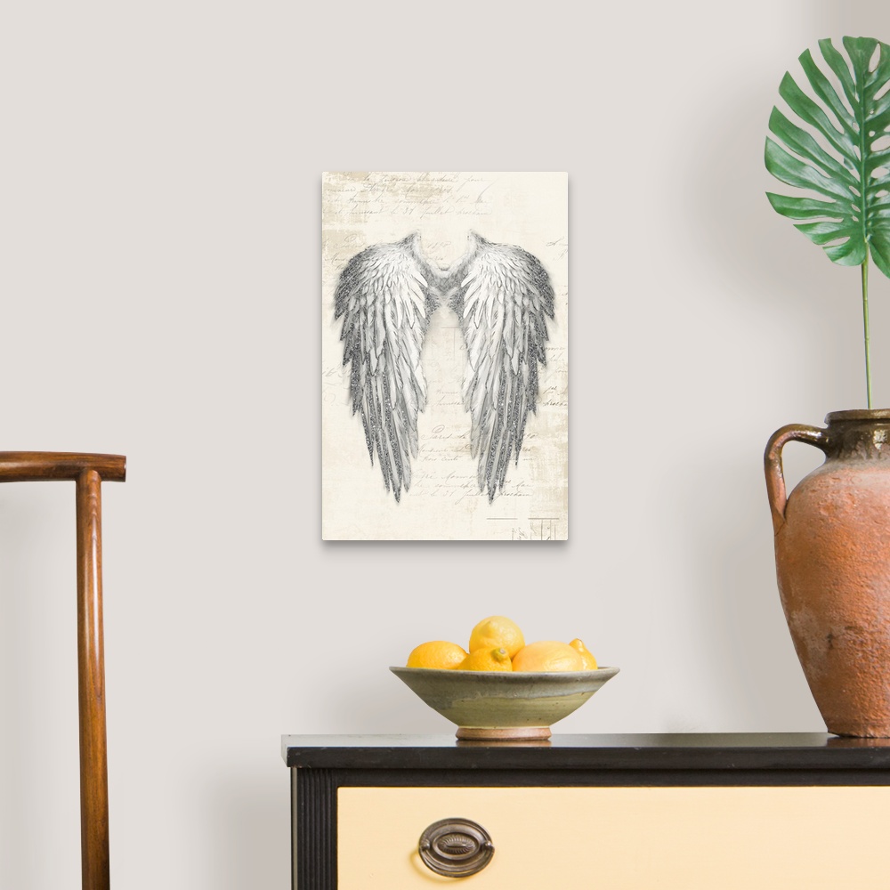 A traditional room featuring A vertical drawing of a pain of angel wings with metallic sliver accents on a neutral backdrop wi...