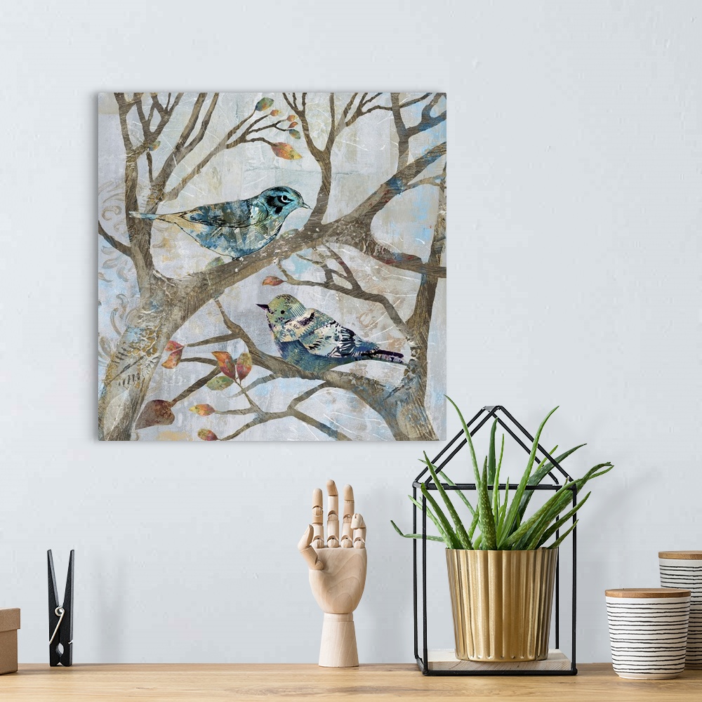 A bohemian room featuring A mixed media painting of two birds perched on tree limbs with hints of printed text and gold acc...