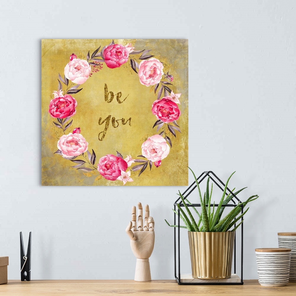A bohemian room featuring Hand-lettered text in a wreath of pink roses on gold.