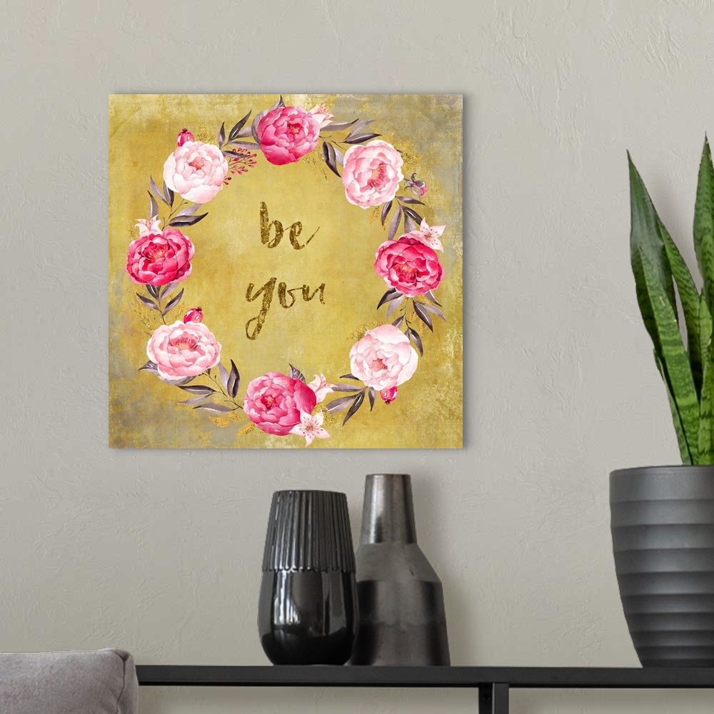 A modern room featuring Hand-lettered text in a wreath of pink roses on gold.