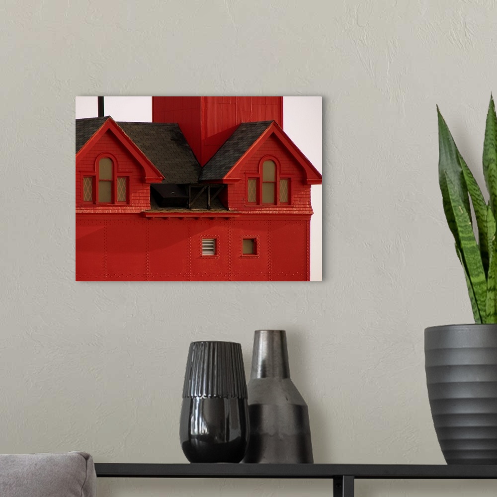 A modern room featuring Contemporary painting of a close-up of a red lighthouse.